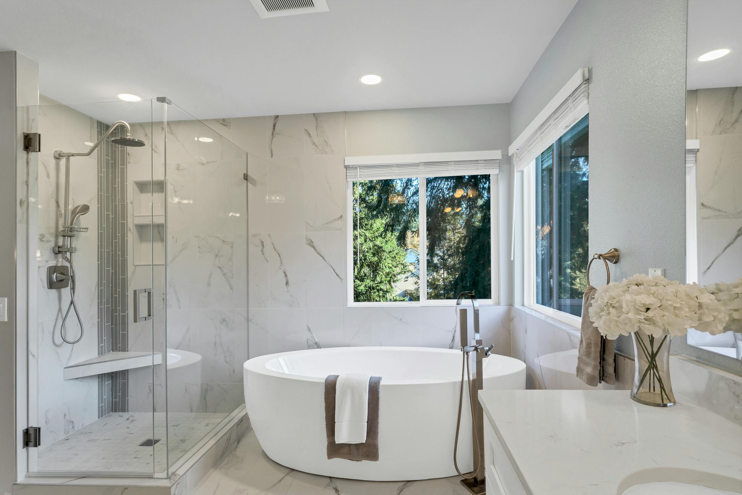 Warm bathroom with freestanding tub and natural light